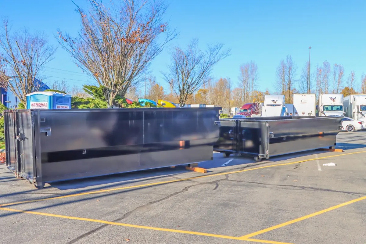 Professional dumpster rental service with roll-off container on residential driveway in Bentonville